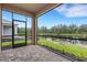 Screened-in patio view of a beautiful pond with a manicured lawn and landscaping at 18068 Cherished Loop, Bradenton, FL 34211