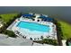 An inviting swimming pool is surrounded by lounge chairs, shade umbrellas, and lush tropical landscaping at 18068 Cherished Loop, Bradenton, FL 34211