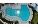 Aerial view captures the community pool with sun loungers and tiled patio at 18068 Cherished Loop, Bradenton, FL 34211
