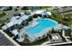 The community pool has a lounge area and a water feature, surrounded by lush landscaping at 18068 Cherished Loop, Bradenton, FL 34211