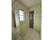 Bathroom with vintage green wallpaper, walk-in shower, and large mirror at 2004 40Th W St, Bradenton, FL 34205