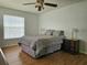 Bedroom featuring a ceiling fan, a large bed, and a wooden nightstand at 2004 40Th W St, Bradenton, FL 34205