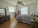Bedroom with a ceiling fan, bed, nightstands, and natural light at 2004 40Th W St, Bradenton, FL 34205