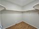 Empty walk-in closet with wood floor and shelving at 2004 40Th W St, Bradenton, FL 34205