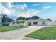 Charming single-story home featuring a well-manicured lawn, palm trees, and a long driveway at 2004 40Th W St, Bradenton, FL 34205