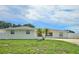 Beautiful single-story home with a lush green lawn and charming palm trees at 2004 40Th W St, Bradenton, FL 34205