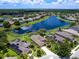 Aerial view of home, neighborhood, and lake at 280 Dahlia Ct, Bradenton, FL 34212