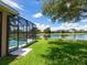 Relaxing backyard featuring screened in pool overlooking a serene lake at 280 Dahlia Ct, Bradenton, FL 34212