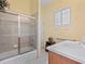 Bathroom featuring tile floors, a shower-tub combo, wood cabinetry, and a single sink at 280 Dahlia Ct, Bradenton, FL 34212