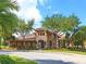 Attractive clubhouse featuring a tile roof, columns, and colorful landscaping at 280 Dahlia Ct, Bradenton, FL 34212
