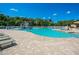 Gathering friendly community pool with zero entry, splash pad, and lounge chairs at 280 Dahlia Ct, Bradenton, FL 34212