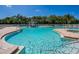 Community pool with splash pad, sun loungers and blue skies at 280 Dahlia Ct, Bradenton, FL 34212