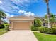 Beautiful home exterior showcasing a well maintained lawn and 2 car garage at 280 Dahlia Ct, Bradenton, FL 34212