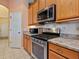 Bright kitchen showcasing modern stainless steel appliances, and natural wood cabinets at 280 Dahlia Ct, Bradenton, FL 34212