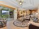 Open concept living area featuring access to the screened lanai, kitchen and dining spaces at 280 Dahlia Ct, Bradenton, FL 34212