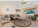Comfortable living room boasts a ceiling fan, an area rug, and a flat-screen television at 280 Dahlia Ct, Bradenton, FL 34212