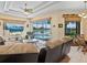 Open-concept living room with pool and lake views, featuring a ceiling fan, and neutral color palette at 280 Dahlia Ct, Bradenton, FL 34212