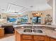 The living room has a view of the lake and features a ceiling fan, plenty of natural light and comfortable furnishings at 280 Dahlia Ct, Bradenton, FL 34212