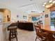 Bright living room offering a ceiling fan, trey ceiling, tiled floor, and seamless transition to the outdoor space at 280 Dahlia Ct, Bradenton, FL 34212