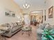 Spacious living room featuring wood floors, comfortable sofas, and elegant chandelier lighting at 280 Dahlia Ct, Bradenton, FL 34212