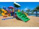 Vibrant community playground featuring multiple slides, climbing structures, and swings set against a serene lake backdrop at 280 Dahlia Ct, Bradenton, FL 34212