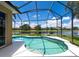 Sparkling pool with a screened enclosure, complemented by picturesque views of the lake and clear blue skies at 280 Dahlia Ct, Bradenton, FL 34212