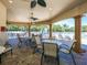 Outdoor poolside lounge area with tables, chairs and ceiling fans at 280 Dahlia Ct, Bradenton, FL 34212