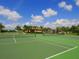 Scenic tennis courts offer an enjoyable playing experience with a lush green surface and picturesque community views at 280 Dahlia Ct, Bradenton, FL 34212
