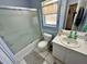 Bathroom featuring a shower-tub, toilet, and single sink with an ornate mirror at 3918 Wake Ave, Sarasota, FL 34241
