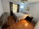 Bedroom with hardwood floors, a window, and a queen sized bed with simple decorations at 3918 Wake Ave, Sarasota, FL 34241