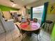 Dining area with a round table, seating four, near the kitchen with white cabinetry at 3918 Wake Ave, Sarasota, FL 34241