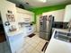 Compact kitchen with white cabinetry, stainless steel refrigerator, and microwave oven at 3918 Wake Ave, Sarasota, FL 34241