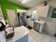 Functional kitchen with white cabinets, tile flooring, and modern stainless steel appliances at 3918 Wake Ave, Sarasota, FL 34241