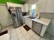 Efficient kitchen features white cabinets, tile floors, and stainless steel appliances at 3918 Wake Ave, Sarasota, FL 34241