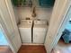 Laundry closet featuring a side-by-side washer and dryer, wire shelving, and bifold doors at 3918 Wake Ave, Sarasota, FL 34241