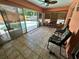 Enclosed patio features tile floors, a ceiling fan, windows, and sliding glass doors to the pool at 3918 Wake Ave, Sarasota, FL 34241
