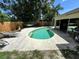 Backyard swimming pool with a hammock, lounge chairs, concrete surround, and garden setting at 3918 Wake Ave, Sarasota, FL 34241