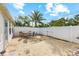 Spacious backyard with white fencing, dining table, and a beautiful palm tree at 441 62Nd St, Holmes Beach, FL 34217