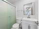 Bright bathroom showcasing a glass door shower, modern vanity, and pristine white fixtures at 441 62Nd St, Holmes Beach, FL 34217