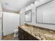 Bathroom featuring a granite countertop vanity, stylish lighting, and shower with a curtain at 441 62Nd St, Holmes Beach, FL 34217