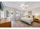 Comfortable bedroom filled with natural light, stylish decor, and beautiful wood-look tile flooring at 441 62Nd St, Holmes Beach, FL 34217