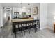 Kitchen with dark breakfast bar, stainless steel appliances, white cabinets, and modern backsplash at 441 62Nd St, Holmes Beach, FL 34217