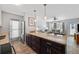 Modern kitchen with stone countertops and stainless steel appliances; open concept living at 441 62Nd St, Holmes Beach, FL 34217