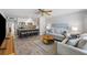 Open-concept living room with modern decor, comfortable seating, and a view into the kitchen and breakfast bar at 441 62Nd St, Holmes Beach, FL 34217