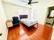 Well-lit bedroom featuring a ceiling fan, desk, and faux wood flooring at 5238 Sunridge Palms Dr, Tampa, FL 33617