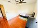 Cozy bedroom features modern ceiling fan, stylish faux wood floors, and a twin bed at 5238 Sunridge Palms Dr, Tampa, FL 33617