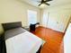Bright bedroom featuring a ceiling fan, faux wood floors, and a work desk at 5238 Sunridge Palms Dr, Tampa, FL 33617
