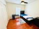 Bedroom with faux wood floors, modern desk and a bed with storage drawers at 5238 Sunridge Palms Dr, Tampa, FL 33617