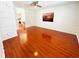Spacious living room featuring sleek, cherry-wood laminate flooring and ample natural light at 5238 Sunridge Palms Dr, Tampa, FL 33617
