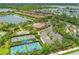 Aerial view of the Bellacina by Casey Key clubhouse with pool, tennis courts, lake and community entrance at 5596 Cantucci St, Nokomis, FL 34275